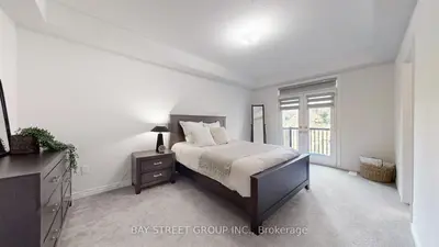 a white bedroom with a bed and a window at Modern in Richmond Hill in Richmond Hill
