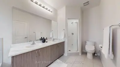 a white bathroom with a sink and a toilet at Modern in Richmond Hill in Richmond Hill