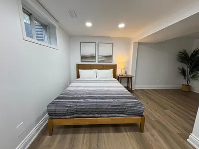 a bedroom with a bed and two windows at North Barrie !A Stylish and Spacious Private Bedroom with Private Bathroom in Barrie