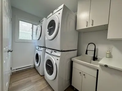 a laundry room with a washer and dryer next to a sink at North Barrie !A Stylish and Spacious Private Bedroom with Private Bathroom in Barrie