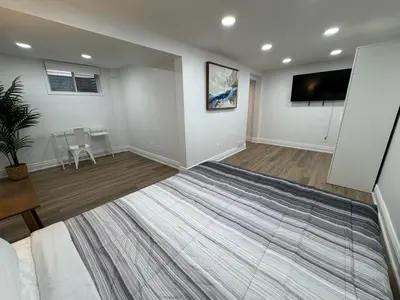 an empty living room with a flat screen tv at North Barrie !A Stylish and Spacious Private Bedroom with Private Bathroom in Barrie