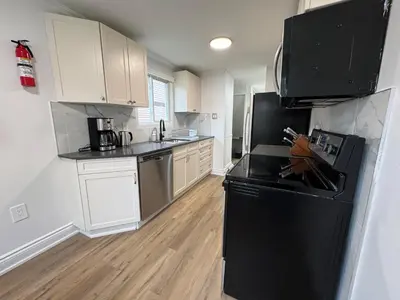 a kitchen with black appliances and white cabinets at North Barrie !A Stylish and Spacious Private Bedroom with Private Bathroom in Barrie