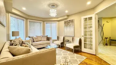 a living room with a couch and chairs and a table at Designer 4BR Retreat, Luxe Living & Family-Friendly Fun in Mississauga