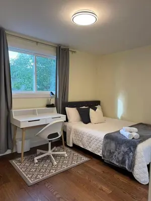 a bedroom with a desk and a bed and a desk and a desk at Quiet Queen Bedroom near Finch Birchmunt in Toronto