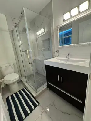 a bathroom with a shower and a toilet and a sink at Quiet Queen Bedroom near Finch Birchmunt in Toronto