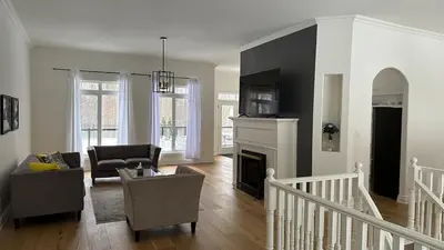 a living room with a couch and a fireplace at Family friendly place with pool in Penetanguishene