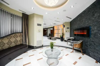 a lobby with a table and a fireplace at PlanURstay - Ideal 2BR & 2 BTH - Near SQ1 Mall in Mississauga