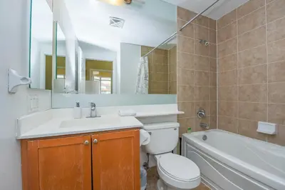 a bathroom with a sink and a toilet and a bath tub at PlanURstay - Ideal 2BR & 2 BTH - Near SQ1 Mall in Mississauga
