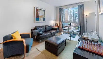 a living room with a couch and a table at Luxury 1-Bedroom Condo in Yorkville, Downtown Toronto in Toronto