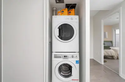 a white washer and dryer in a room at Chic 2BR Condo Toronto Core Steps to Eaton Centre in Toronto