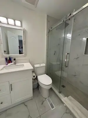 a bathroom with a toilet and a glass shower at Quite room finch birchmunt in Toronto