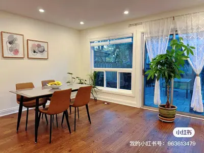 a dining room with a table and chairs and a plant at Quite room finch birchmunt in Toronto