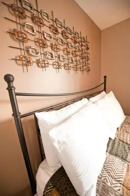 a bedroom with a bed with white pillows at Misty Retreat in Niagara Falls