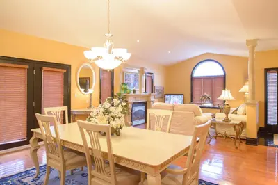a dining room and living room with a table and chairs at STONEHAVEN RETREAT in Niagara Falls