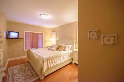 a bedroom with a white bed and a window at STONEHAVEN RETREAT in Niagara Falls