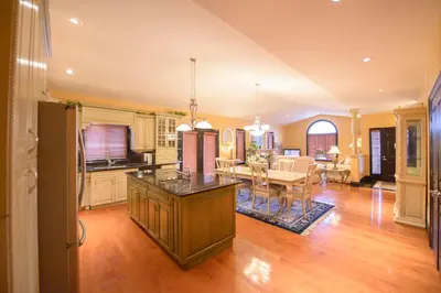 a kitchen and living room with a table and a dining room at STONEHAVEN RETREAT in Niagara Falls