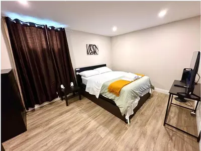 a bedroom with a bed and a television in it at 1-Bedroom 1Bathroom Entire Unit closer to Fairview Mall & Waterloo Airport in Kitchener