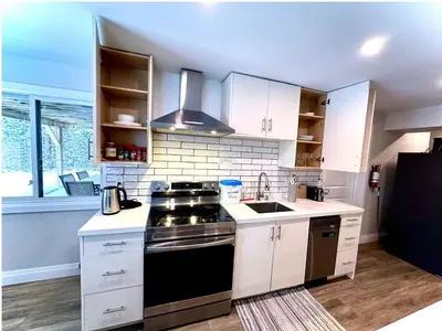 a kitchen with white cabinets and a stove top oven at 1-Bedroom 1Bathroom Entire Unit closer to Fairview Mall & Waterloo Airport in Kitchener