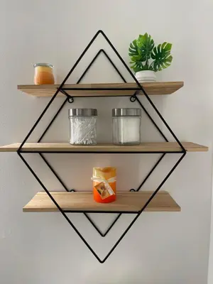 a black and wooden shelf hanging on a wall at Academic Oasis in London