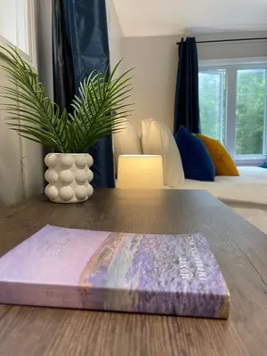 a table with a book and a vase on it at Academic Oasis in London