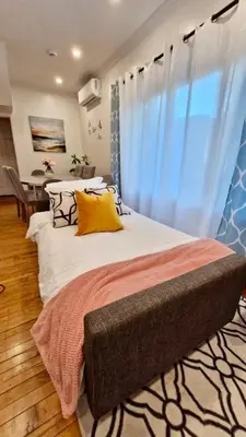 a bedroom with a large bed with a window at Academic Oasis in London