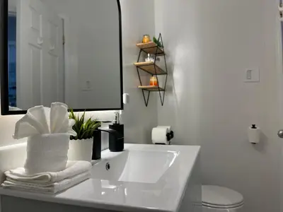 a white bathroom with a sink and a mirror at Academic Oasis in London