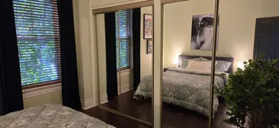a bedroom with a mirror and a bed at New York Style Brownstone Elegant Home in Toronto's Vibrant King West in Toronto