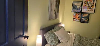 a bedroom with a bed with a light next to a door at New York Style Brownstone Elegant Home in Toronto's Vibrant King West in Toronto