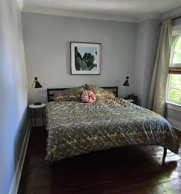 a bedroom with a bed with a comforter on it at New York Style Brownstone Elegant Home in Toronto's Vibrant King West in Toronto