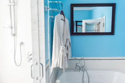 a bathroom with a sink and a mirror and a tub at New York Style Brownstone Elegant Home in Toronto's Vibrant King West in Toronto