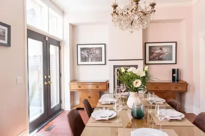 a dining room with a table and chairs and a chandelier at New York Style Brownstone Elegant Home in Toronto's Vibrant King West in Toronto