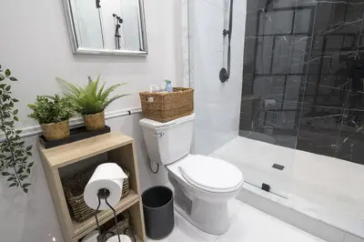 a bathroom with a toilet and a shower at Spacious 4 Bdrm, Lake Views, Steps from the Beach in Tiny