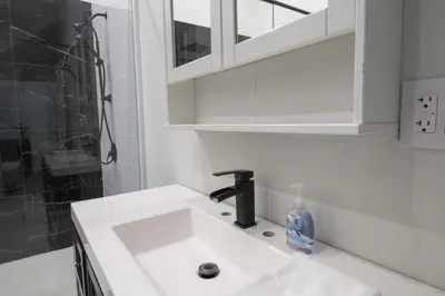 a bathroom with a sink and a shower at Spacious 4 Bdrm, Lake Views, Steps from the Beach in Tiny