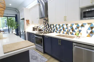 a kitchen with blue cabinets and a sink at Spacious 4 Bdrm, Lake Views, Steps from the Beach in Tiny
