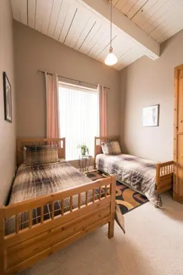 a bedroom with two beds and a window at PRESIDENTIAL SUITE in Niagara Falls