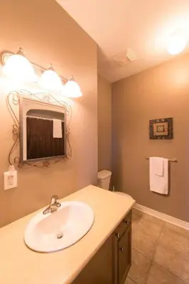a bathroom with a sink and a mirror at PRESIDENTIAL SUITE in Niagara Falls