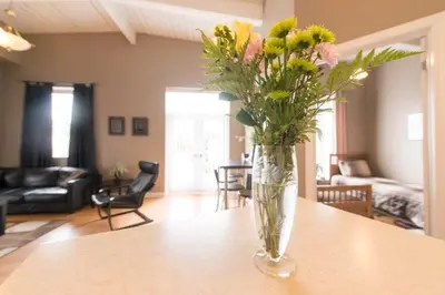 a vase of flowers on a table in a living room at PRESIDENTIAL SUITE in Niagara Falls