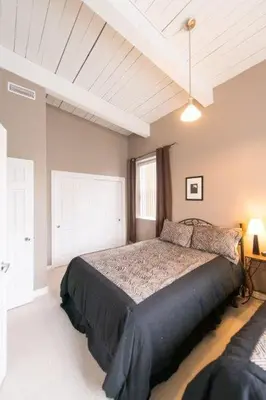 a bedroom with a large bed in a room at PRESIDENTIAL SUITE in Niagara Falls