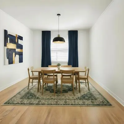 a dining room with a table and chairs on a rug at RIVERSIDE STAY in Niagara Falls