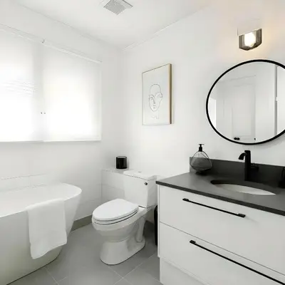 a white bathroom with a sink toilet and a mirror at RIVERSIDE STAY in Niagara Falls