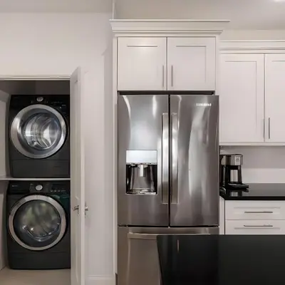 a kitchen with a refrigerator and a washer and dryer at RIVERSIDE STAY in Niagara Falls