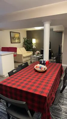 a table with a plaid table cloth on it in a living room at Cozy Private Basement Suite Beside Plaza Free Parking Walk to Groceries & Dining in Richmond Hill