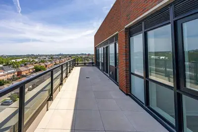 a balcony of a brick building with a view of a city at Spacious 3BR Loft with Balcony and Free Parking in Toronto