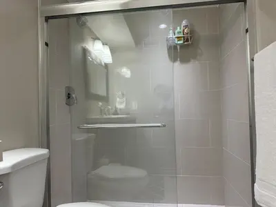 a bathroom with a glass shower with a toilet at Cozy and comfy 2 Bed rooms in Mississauga