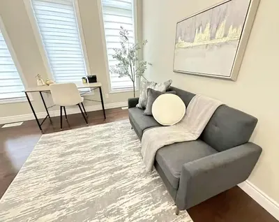 a living room with a couch and a table at Fieldstone Estate in Tillsonburg