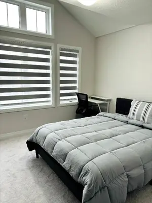 a bedroom with a large bed and two windows at Cozy Private Room with ensuite in Shared Home in Ayr in Paris