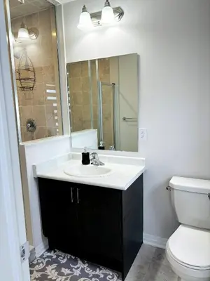 a bathroom with a sink and a toilet and a mirror at Cozy Private Room with ensuite in Shared Home in Ayr in Paris