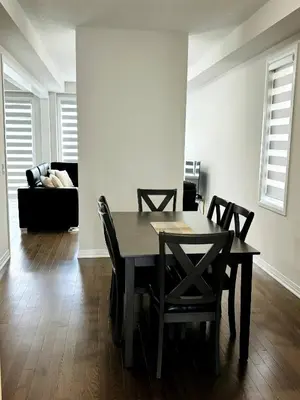 a dining room with a table and chairs and a couch at Cozy Private Room with ensuite in Shared Home in Ayr in Paris