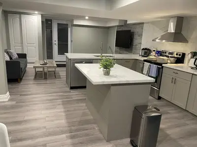 a kitchen with a island in the middle of it at Bright & Cozy Basement Retreat in Oshawa