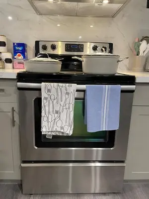 a kitchen stove with two pans on top of it at Bright & Cozy Basement Retreat in Oshawa